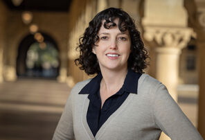 Photo of Molly Schumer wearing a being sweater over a black collared blouse