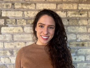 Laura Brady standing in front of light tan brick wall