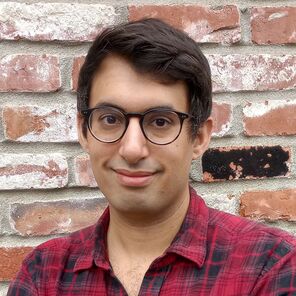 Photo of Matthew Swaffer wearing glasses and a black-and-red plaid shirt