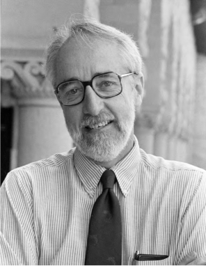 Image of Norman Wessells in front of a marble column