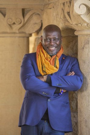 Image of Ato Quayson standing next to a pillar