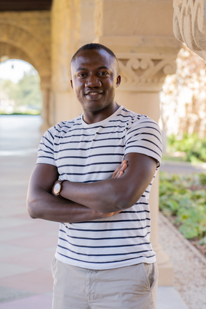 Barnabas Daru standing in the Stanford arcade arches