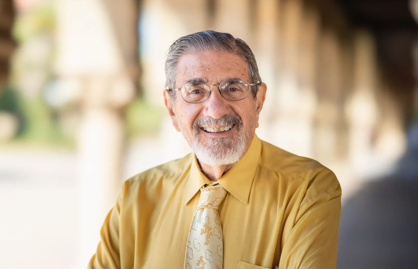 Photo of Richard Zare in a yellow-button down shirt and yellow tie