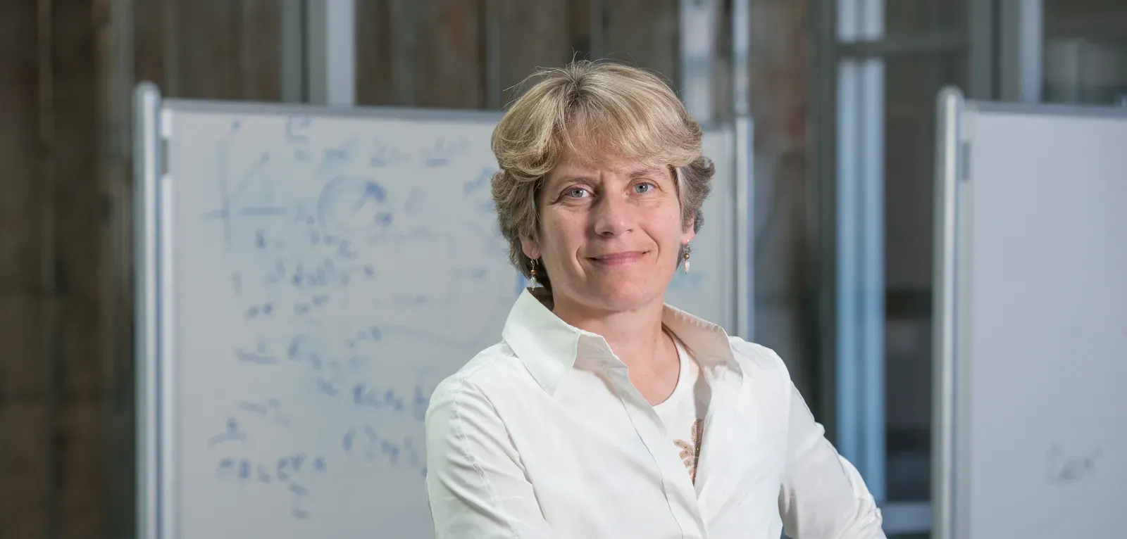 Portrait of Carolyn Bertozzi in front of a white board