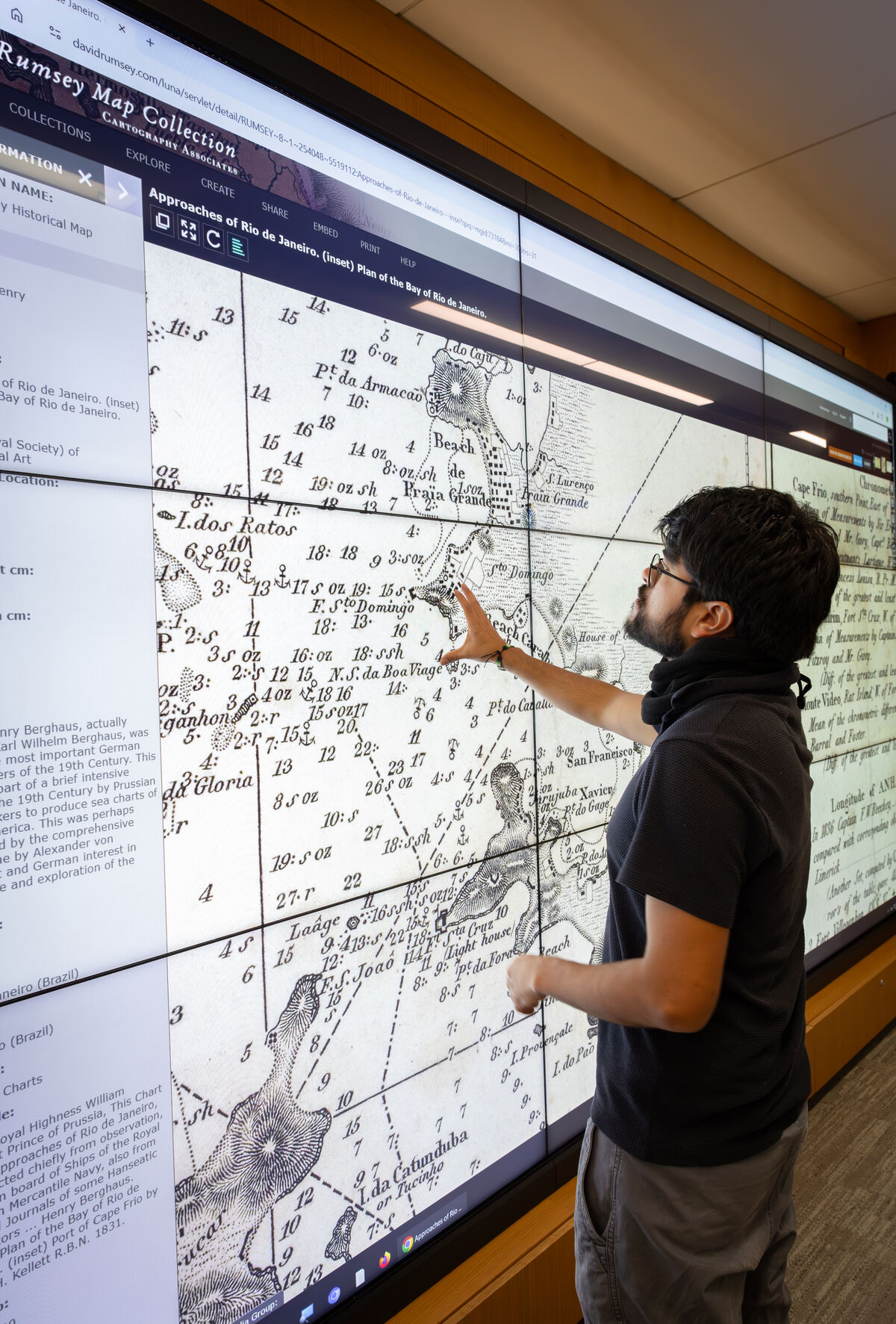 Student Christian Robles-Baez explores the Rumsey Map Collection's digital wall