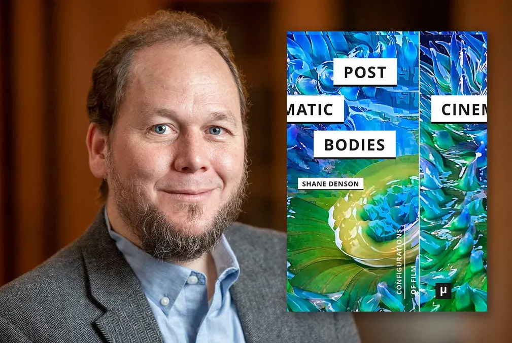 Shane Denson, author of Post-Cinematic Bodies, with the cover of his book featuring a flower with green leaves as petals surrounded by sky-blue buds and swirls