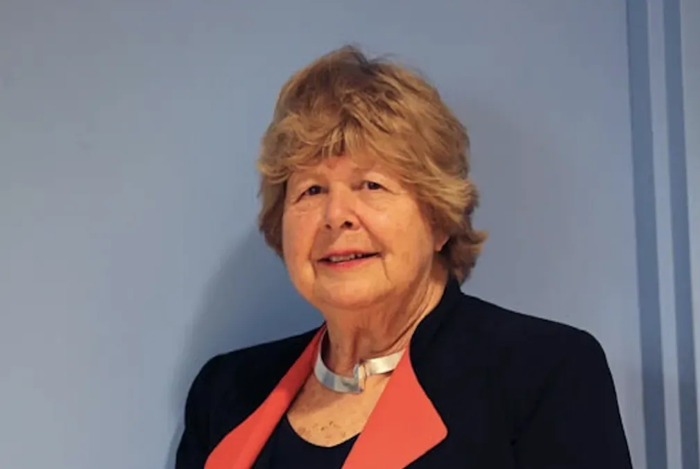 Marjorie Perloff standing in a black suit