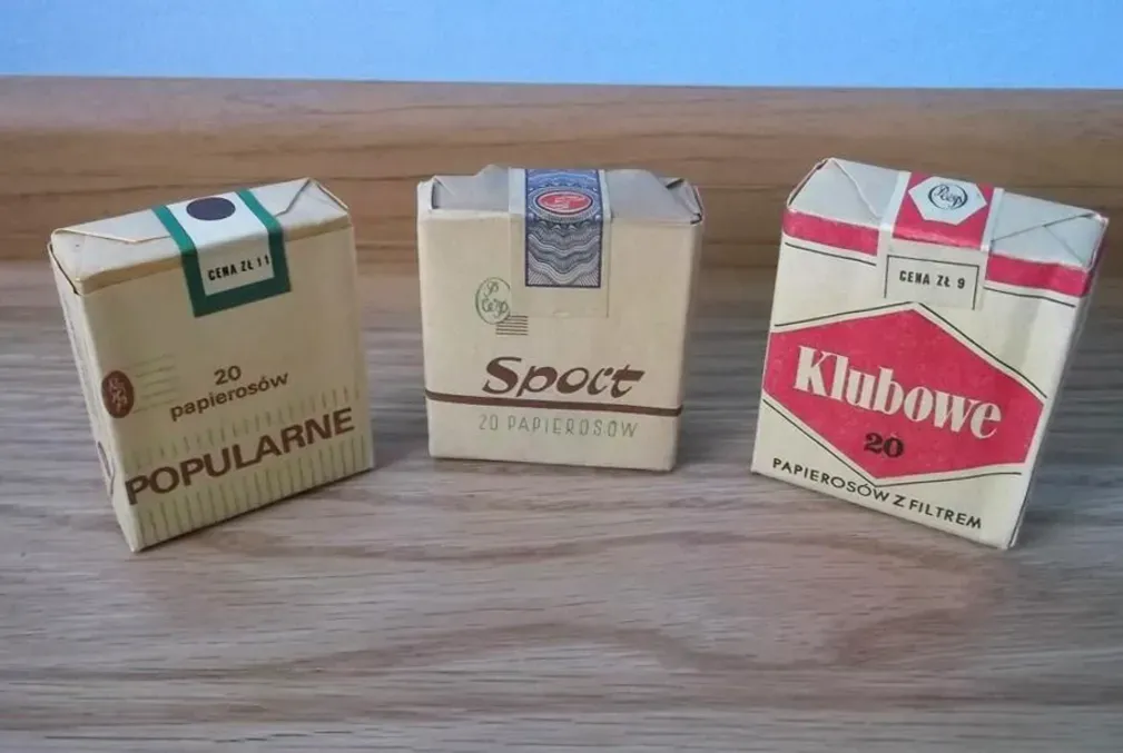 Three packets of European cigarettes sitting upright on a table